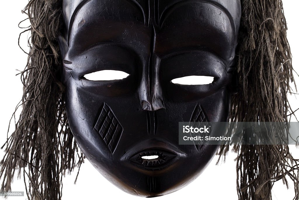 Black tribal face mask on white background Africa Stock Photo