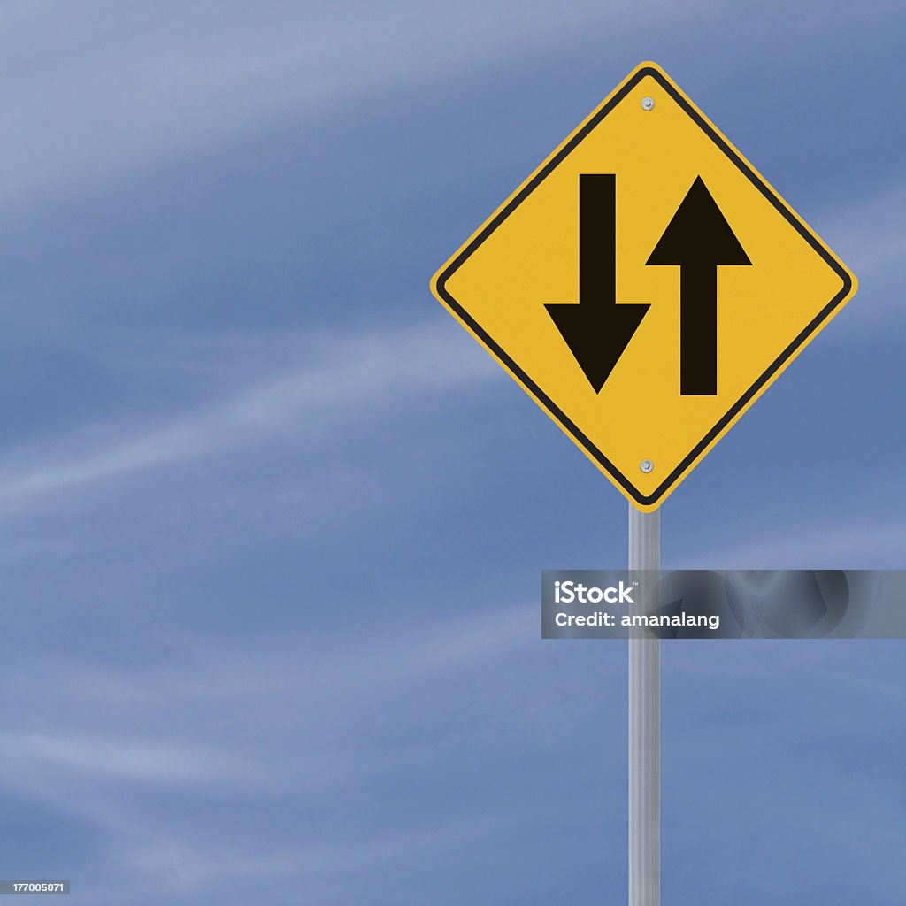 Two Way Road Sign Two way road sign on a blue sky background with copy space Sign Stock Photo