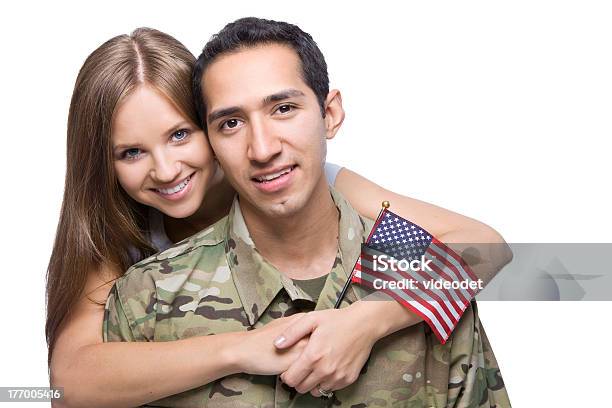 Man In Army Uniform Hugged By Young Woman Holding Us Flag Stock Photo - Download Image Now