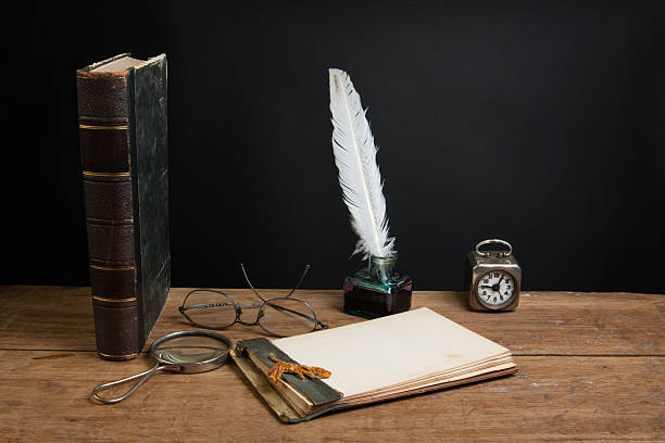 istock Quill, magnifying glass, old notepad, spectacles, book, clock on wood 177005474