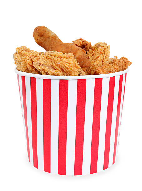 Fried chicken in big red white stripes bucket box stock photo