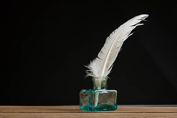 istock Empty glass inkwell and quill on oak wooden table 177006312
