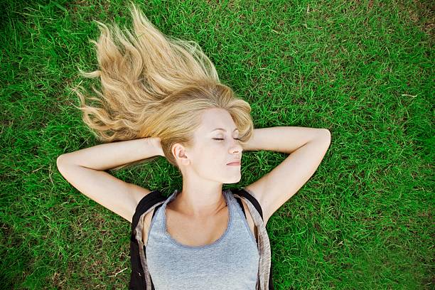 istock Blonde girl lying on grass 177006686