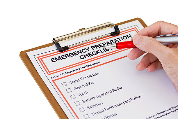 Hand completing Emergency Preparation List stock photo