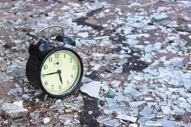 alarm clock on shattered glass Vintage alarm clock on shattered glass. Little of grain added for the mood smash alarm clock stock pictures, royalty-free photos & images