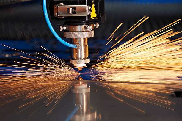Laser cutting of metal sheet with sparks stock photo