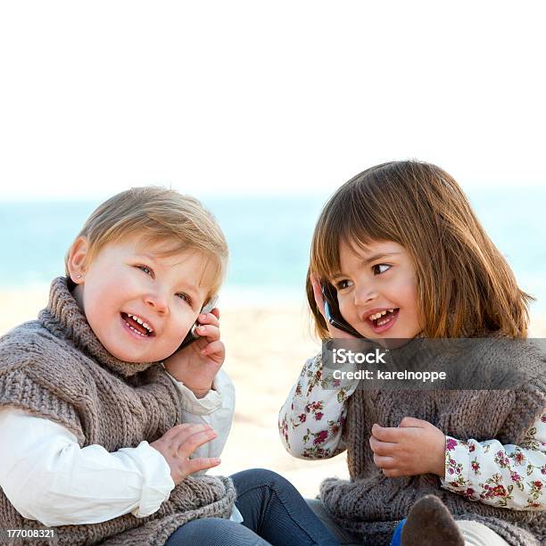 Infants Having Conversation By Phone Stock Photo - Download Image Now - Baby - Human Age, Baby Girls, Beach