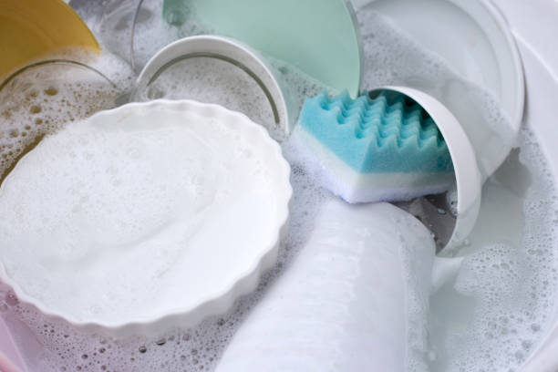 istock Dishes and bowls in water and bubbles of dishwashing liquid. Kitchen work 1770083376