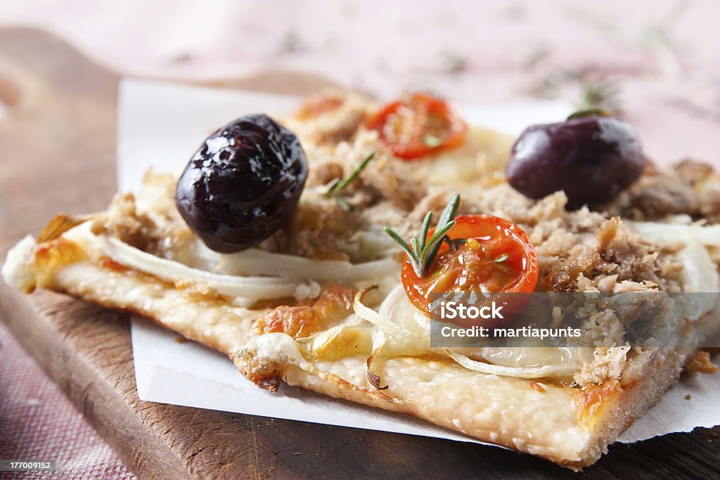 pizza with onions, tuna, tomatoes and olives "pizza with onions, tuna, tomatoes and olives on wooden table" Cheese Stock Photo