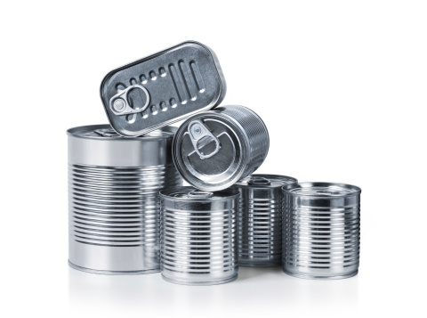 Pile of cans of conserved food over white background