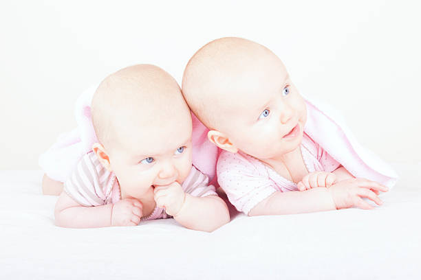 istock identical baby twin sisters 177010899