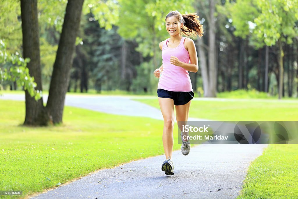 Running woman in park Running xwoman in park in summer training. Asian sport fitness model in sporty running clothes. Click for more: Fashion Model Stock Photo