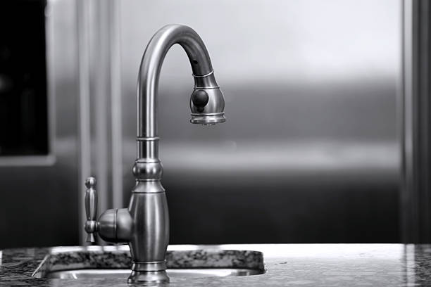 Water flowing from chrome faucet into the bathtub, Preparation for relaxation time. Luxury home interior object.
