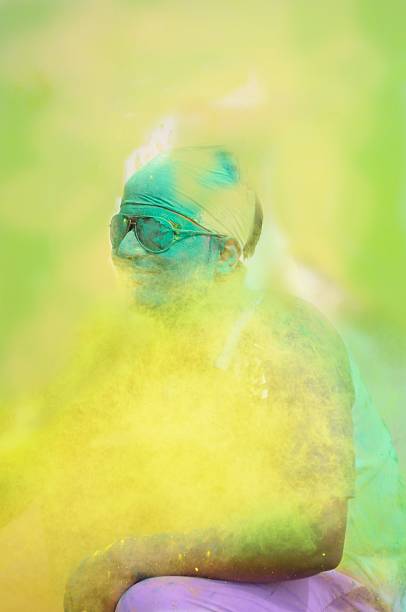 Close up of an Indian boy playing holi in India.