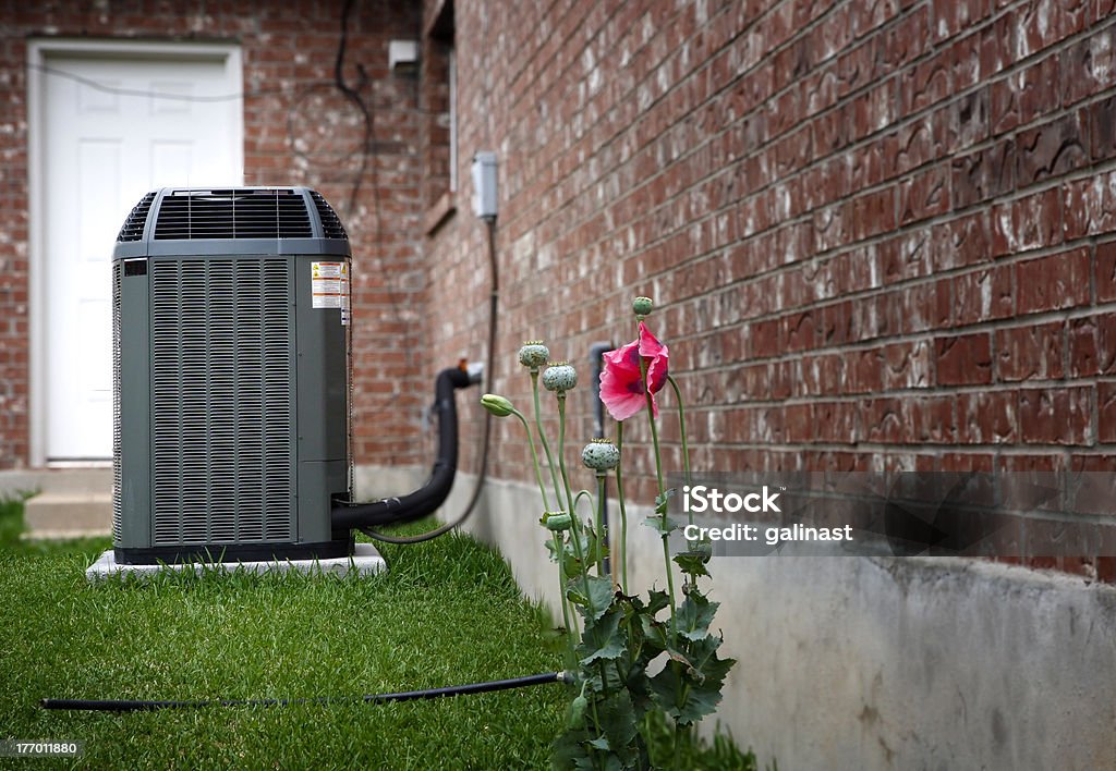 AC on house backyard "High efficiency modern AC-heater unit, energy save solution on backyard" Air Conditioner Stock Photo