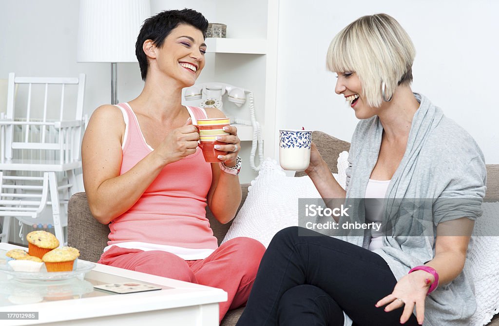 two happy woman friends two happy woman friends chatting and smiling over coffee and cakes 30-39 Years Stock Photo