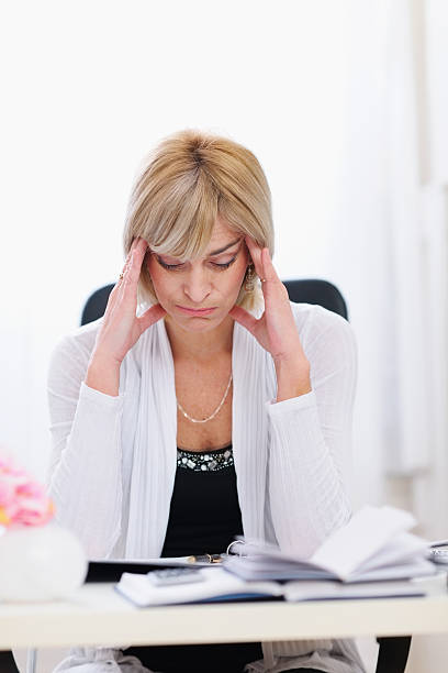 istock Stressed senior business woman sitting at office table 177013164