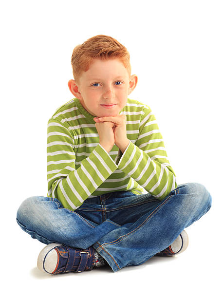 adorable child sitting on the floor isolated on white background