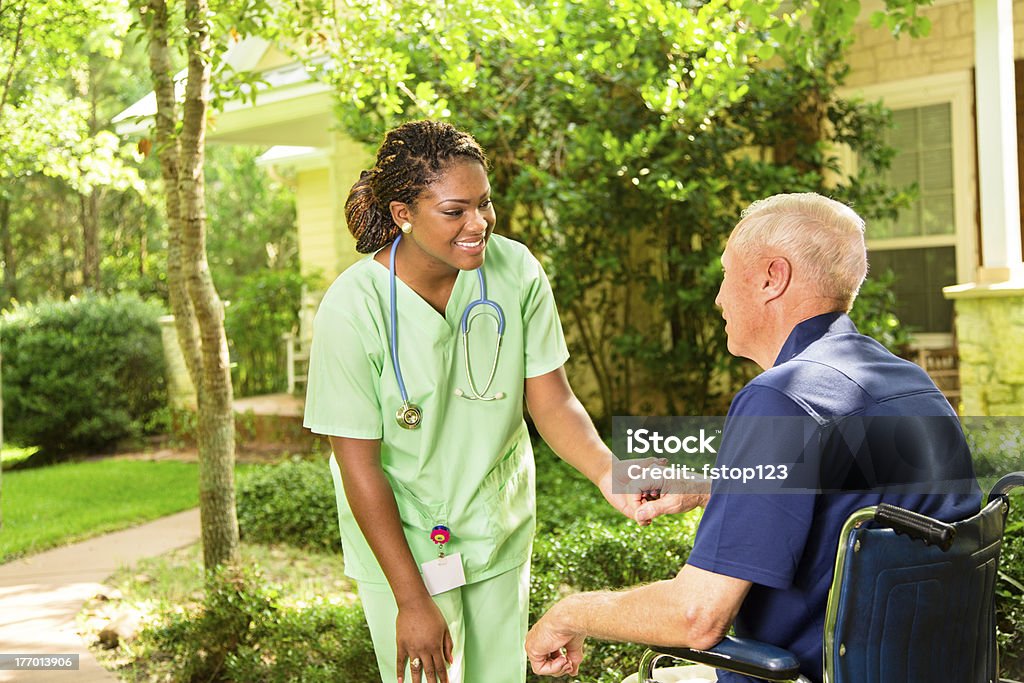 Médicos: Gosto dele cuida a visitar com idoso em cadeira de rodas. - Royalty-free Assistente Domiciliar Foto de stock