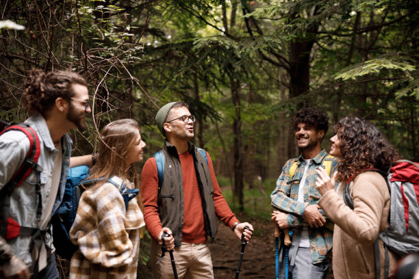 istock Young happy hikers talking on a break in forest. 1770140768