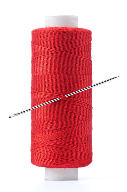 istock Spool of thread and needle  isolated on white background 177014125