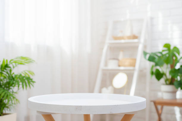 istock Closeup of round empty table in blurred spa room with curtained window 1770141909