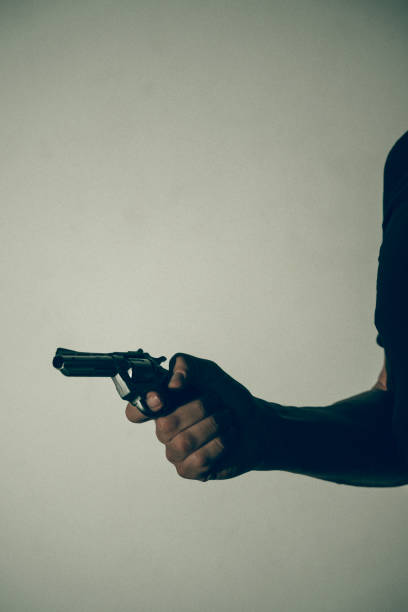 istock Gunman killer holding pistol artistic photo 1770142430