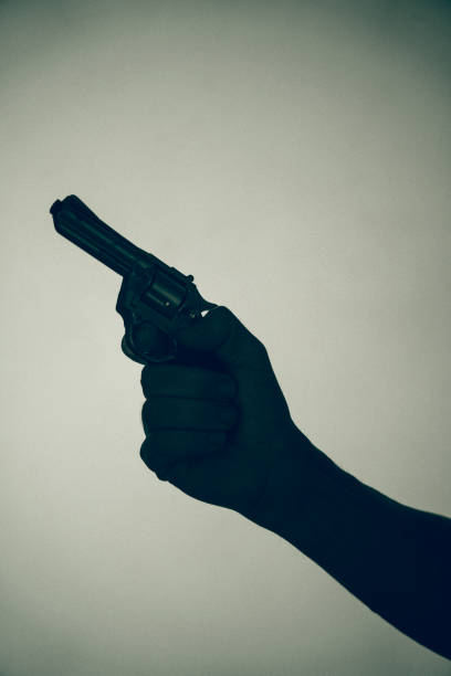 istock Gunman killer holding pistol artistic photo 1770142465