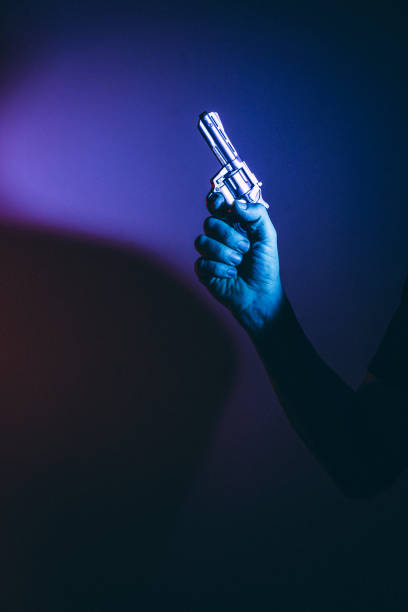 istock Gunman killer holding pistol artistic photo 1770142995