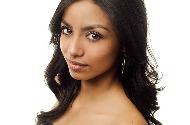 Beautiful young exotic woman isolated against white background.
