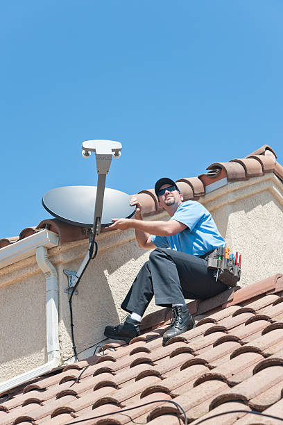 Installation of satellite dish TV system in sitting position.