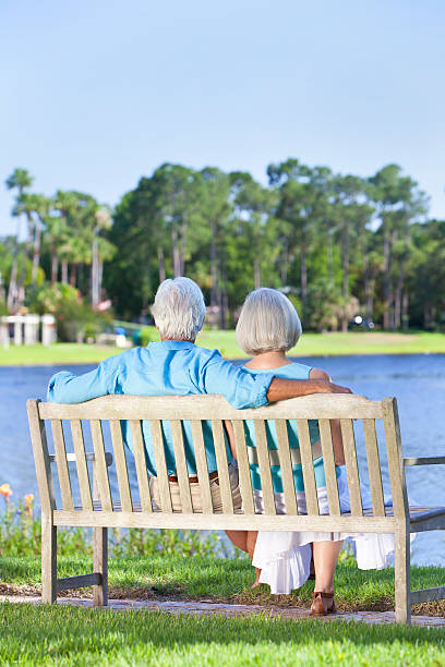 istock Rear View Senior Couple Sitting On Park Bench 177016094