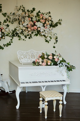 An old white piano. Vintage musical instrument