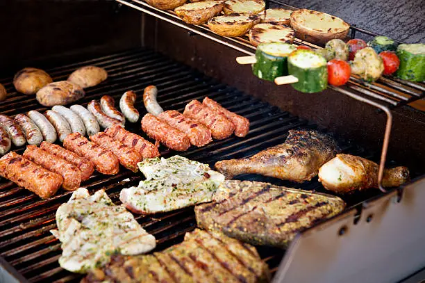 Vegetables, steak and other meat on a BBQ