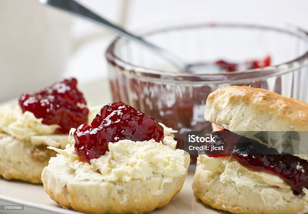 Scones with strawberry jam and clotted cream. Home-baked scones tea with strawberry jam and clotted cream. Shallow depth of field.For similar photos please check out my Scone Stock Photo
