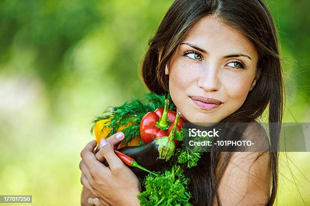 Brunette Woman Holding Vegetables In Arms Stock Photo - Download Image Now - Adult, Adults Only, Beautiful People