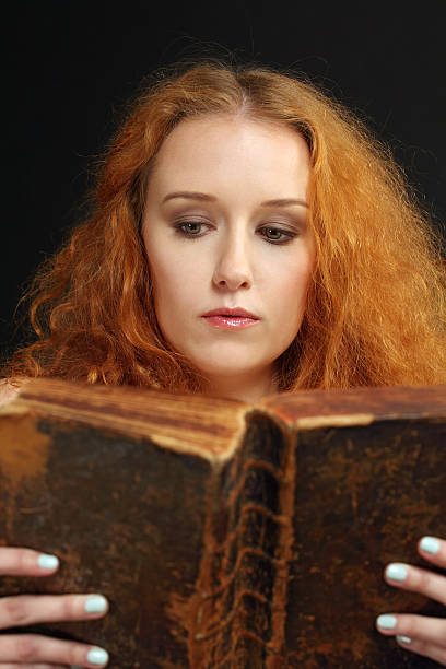 istock Young woman reading an old bible 177017527