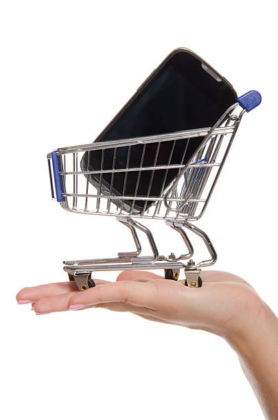 istock smartphone and shopping trolley on the palm isolated in white 177017715
