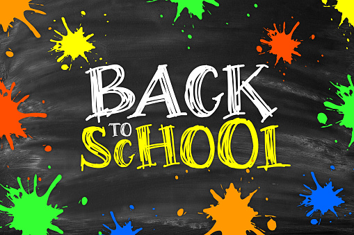 Chalkboard with BACK TO SCHOOL lettering and multi colored ink blobs. Blackboard with chalk traces and smudges.
