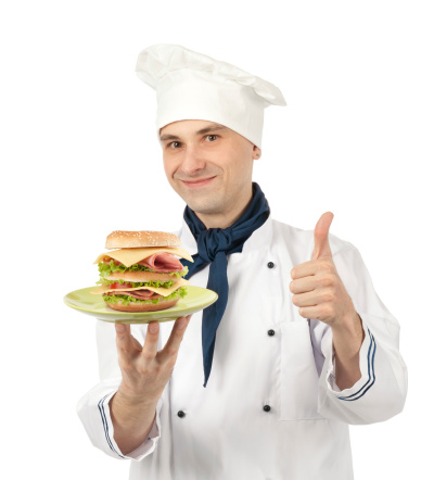 Chef holding a plate with big sandwich