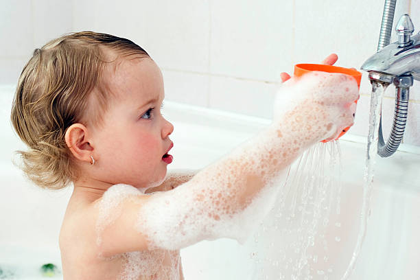 istock Baby girl playing with water 177018610