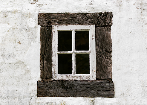 Antique old residential window frame on a white background with panes blacked out. Abstract background.