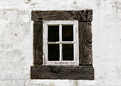 Antique old residential window frame on a white background with panes blacked out.