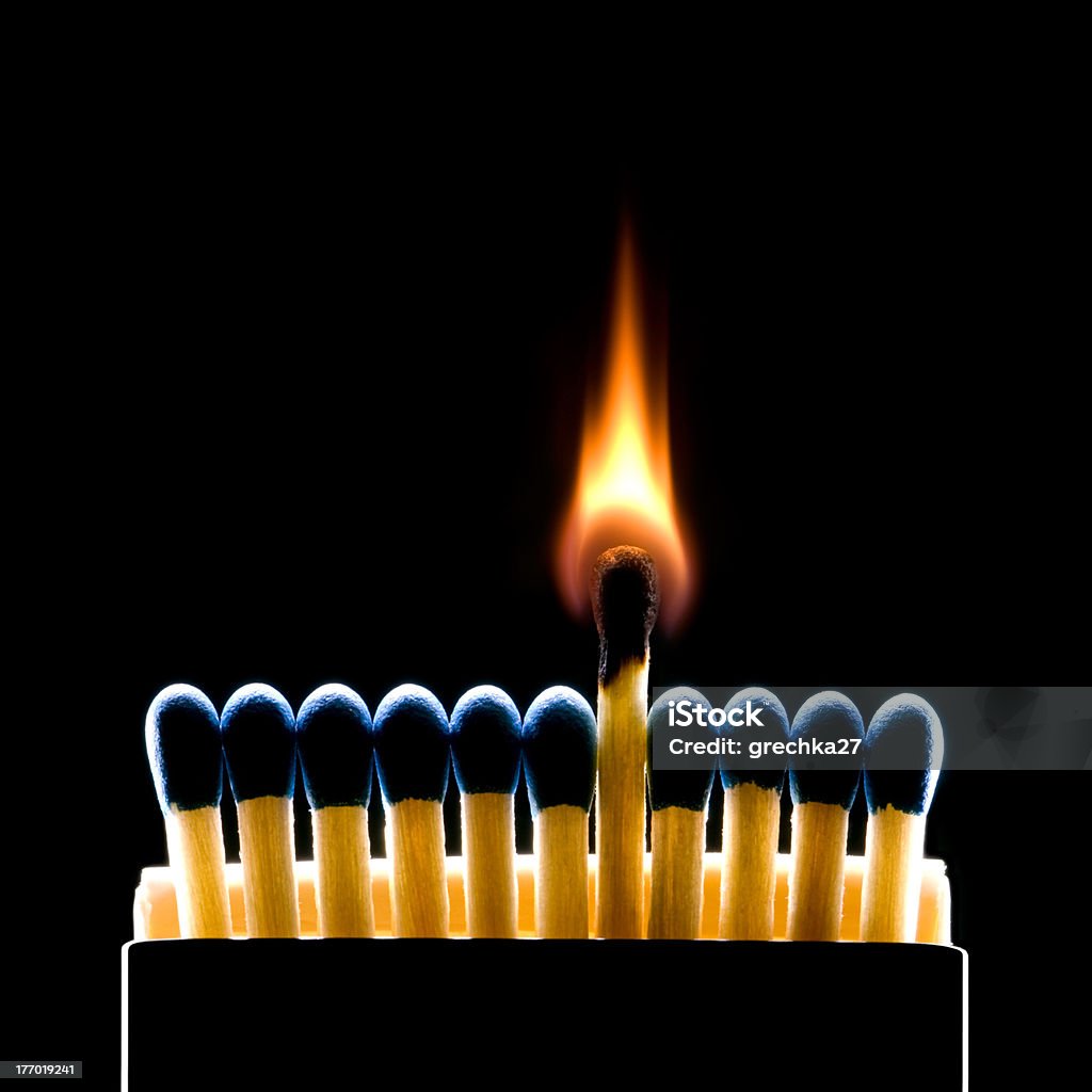 Main recesses (matches - a metaphor) Many dark blue matches on a black background (one match burns). Arts Culture and Entertainment Stock Photo