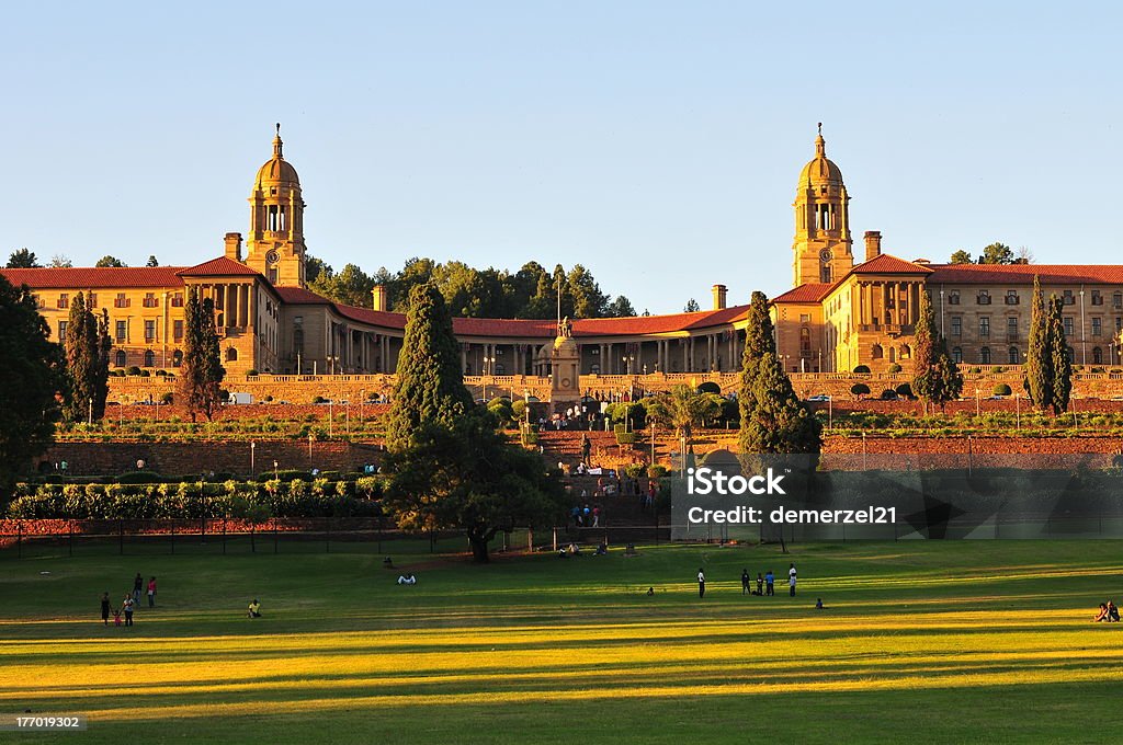 Union Buildings, Pretoria at Sunset "South African Union Buildings seen here at sundown. The Union Buildings were built from light sandstone and designed by the Sir Herbert Baker in the English monumental style. The Buildings are over 275 m long and a semi-circular shape, with the two wings at the sides that represent the union of a formerly divided people. (English and Afrikaans). The Union Buildings are considered by many to be the architect's greatest achievement and a South African architectural masterpiece. The cornerstone was laid in November 1910. Requiring over 1,265 workers over 3 years to build, the structure was completed in 1913. Today, the official seat of the South African government and also the offices of the President of South Africa." Pretoria Stock Photo