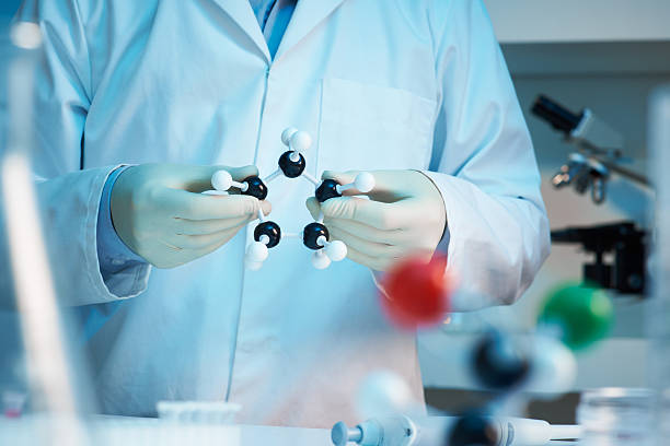 Scientist holding molecular model stock photo