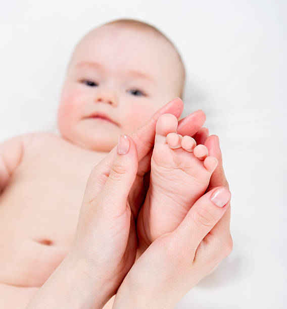 istock Mother massaging her baby 177019876