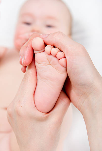 istock Mother massaging her baby 177019879