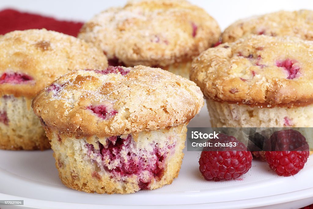Raspberry Muffins and Fruit Several whole cranberry muffins and raspberry fruit on a platter Muffin Stock Photo
