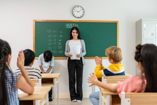 istock Group of student learn with teacher in classroom at elementary school. Attractive beautiful female instructor master explain and educate young children with happiness and fun activity at kindergarten. 1770214888